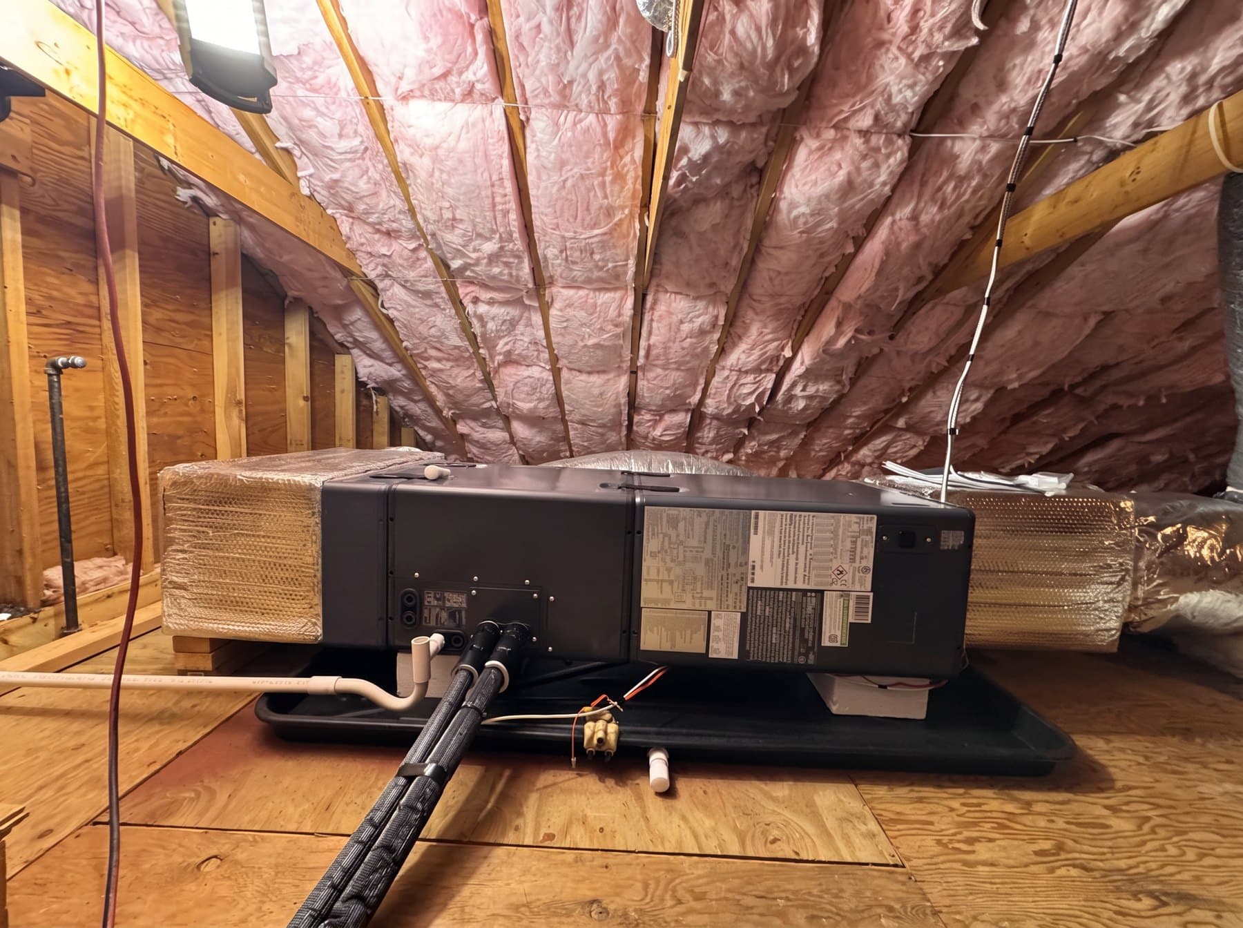 Refrigerant line set routed and sealed through a basement ceiling